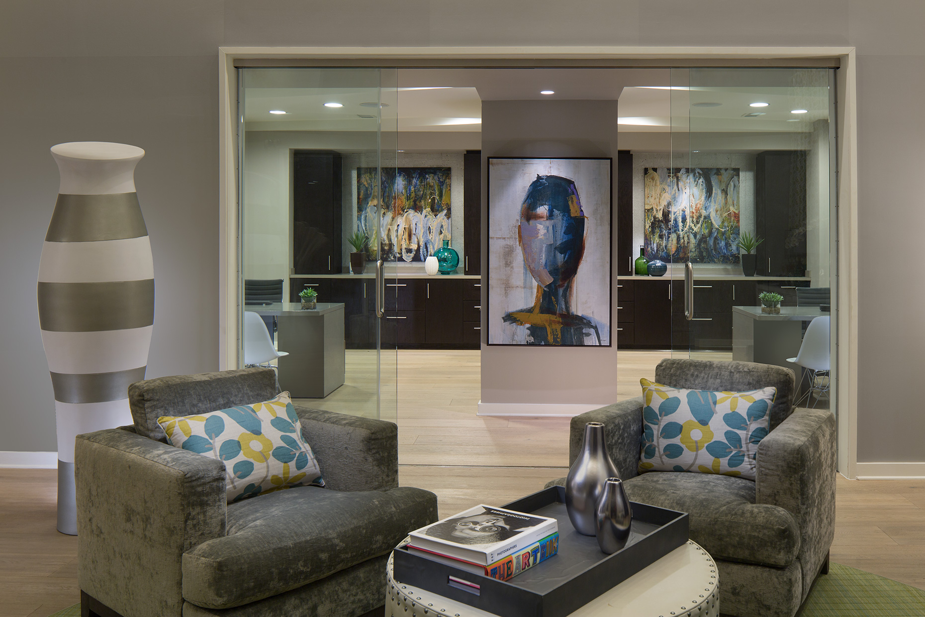 An interior photo of the lobby of @1377 Apartments highlighting the bold art and comfortable seating
