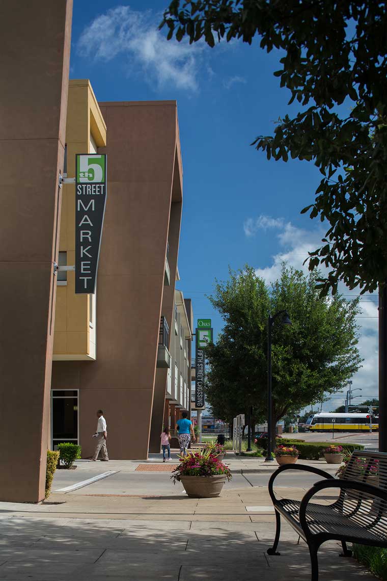 A sidewalk view of the retail and public transit aspects of the Garland City Center in Garland, TX