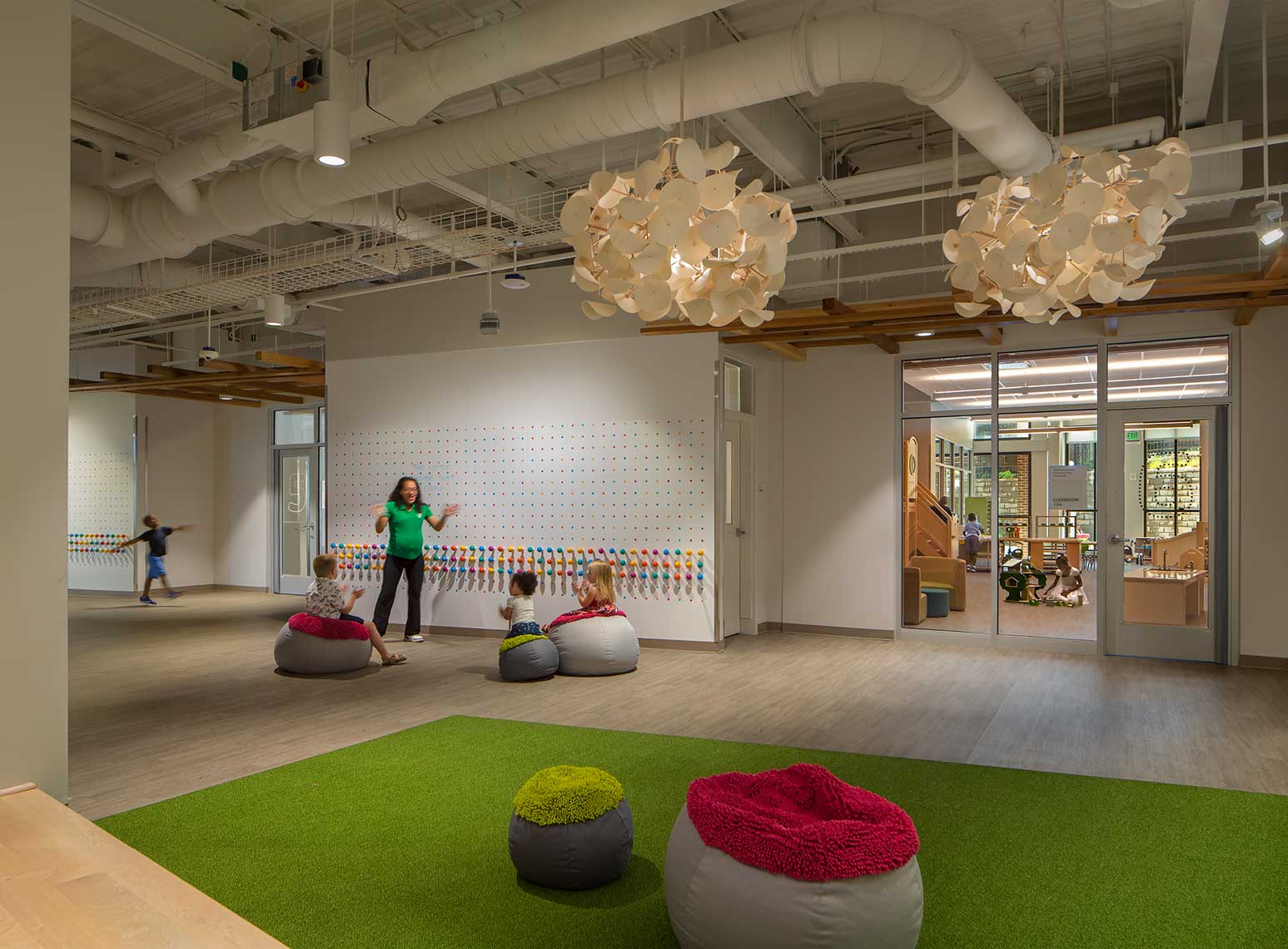 A fun and engaging photo of teachers and students in the Early Learning Center