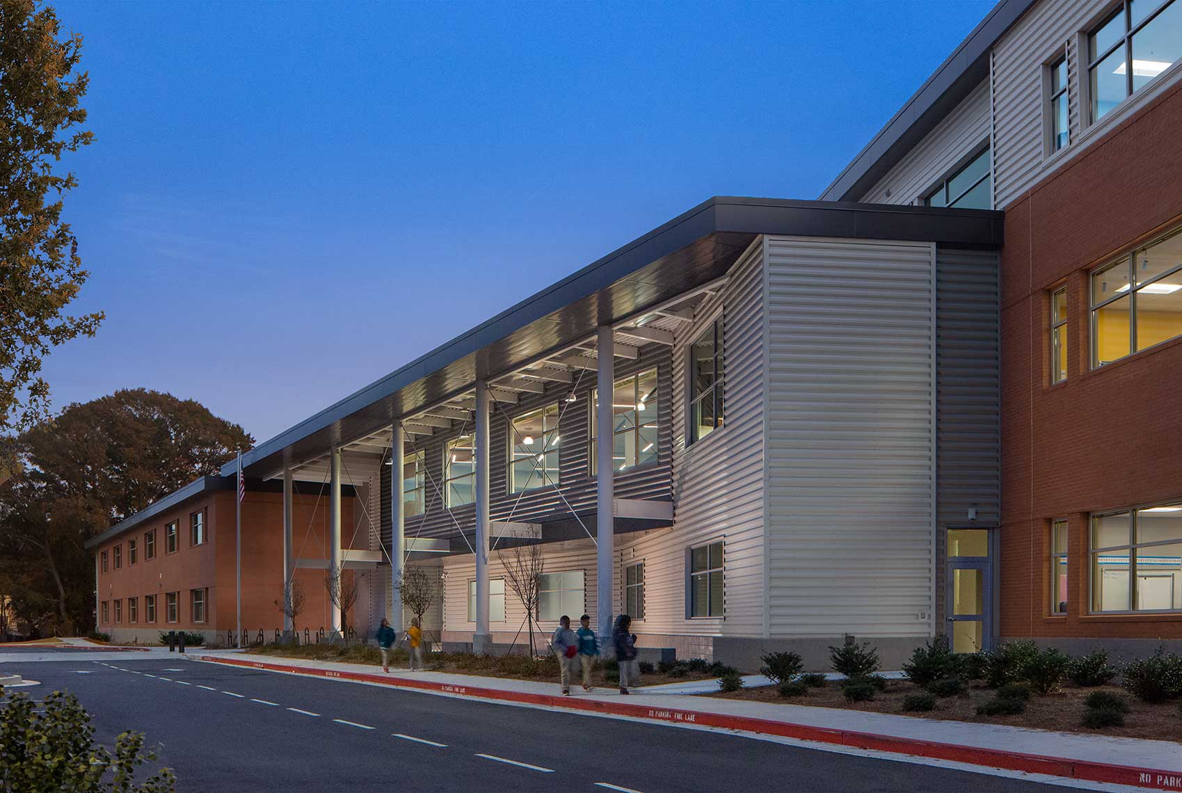 A twilight view of the entry at the Tuskegee Airmen Global Academy