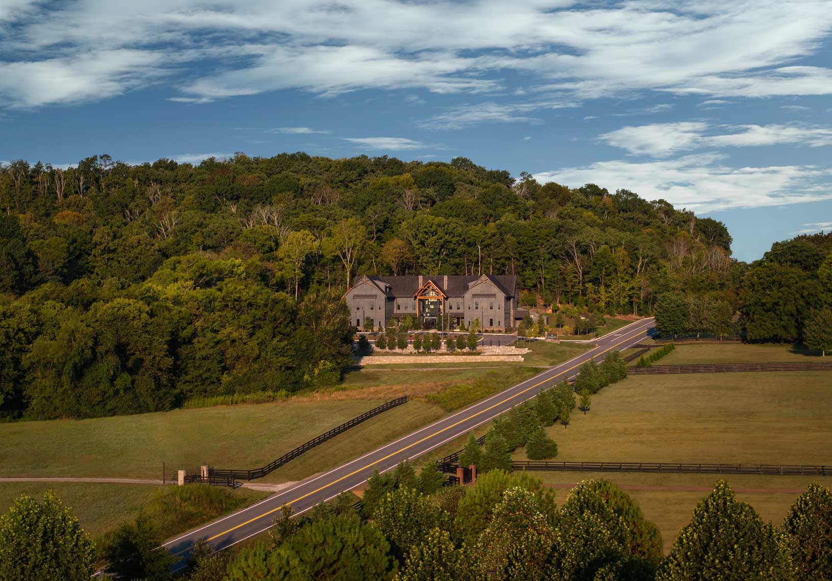 An elevated drone view of The Refuge Center for Counseling in Franklin, TN, and the surrounding fields and landscape