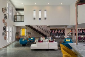 The seating, library, and mail areas in the lobby of the Spoke at Edgewood-Candler Apartments