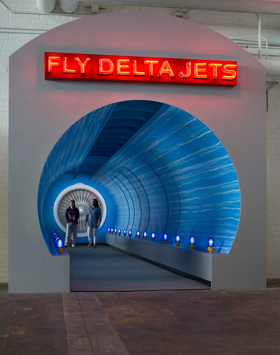 Interior view of a transition tunnel between airplane exhibits at the Delta Flight Museum