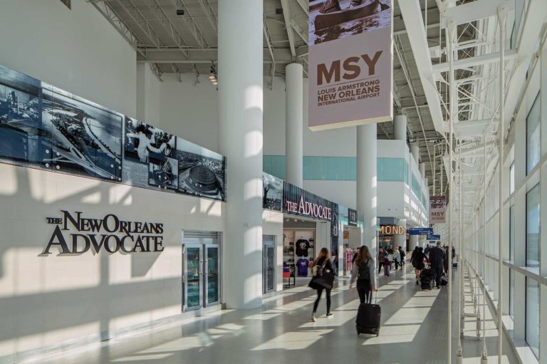 Interior daytime view of a walkway with travelers at the MSY North Terminal - Atlanta Architectural Photographers