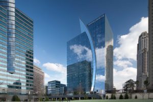 Daytime view of the architecture at Two Alliance Center silhouetted by the surrounding buildings