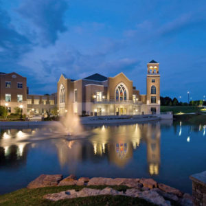 A twilight exterior view across the water of the Cecil B. Day Chapel at Perimeter Church