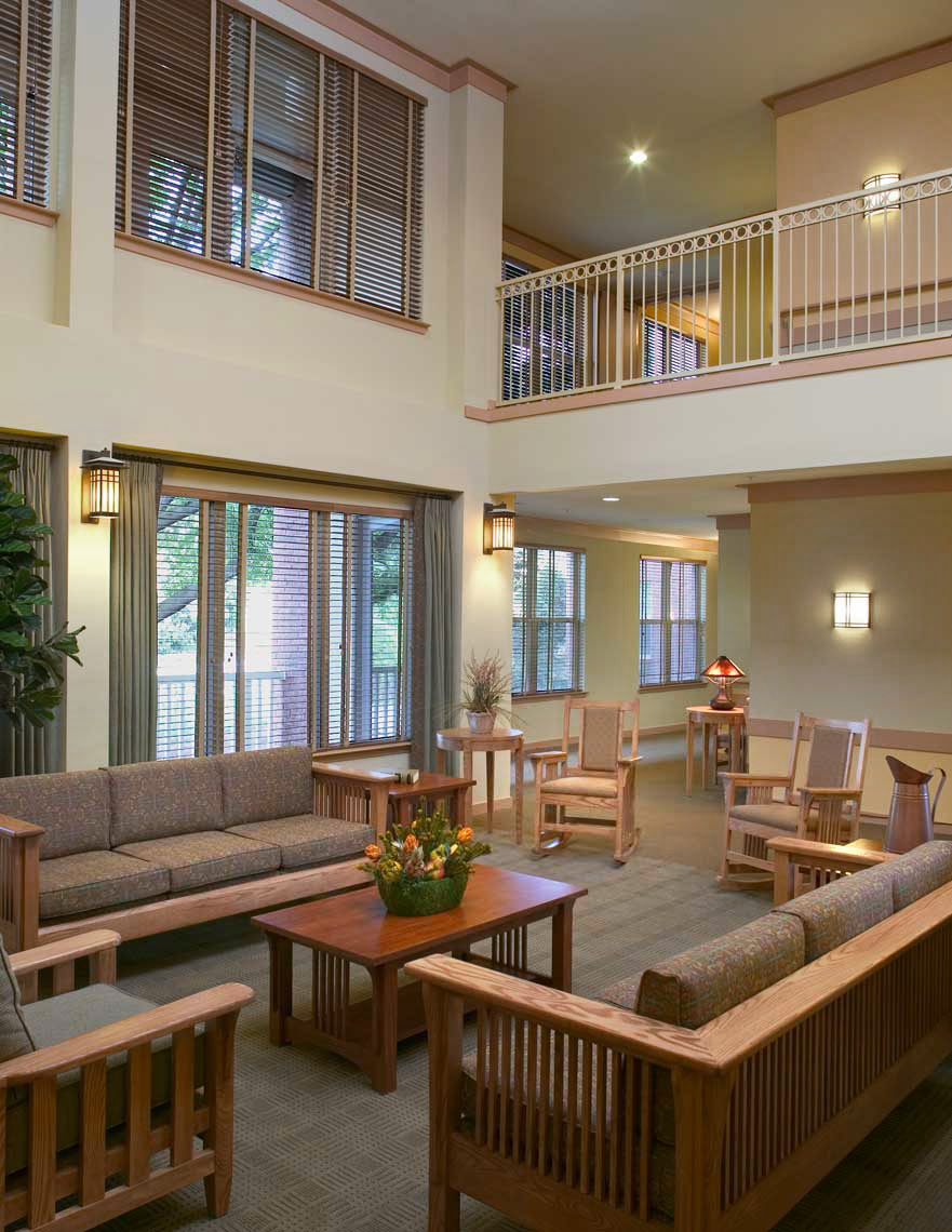 A photograph of the inviting two-story Gathering Room at Columbia Heritage Senior Residences