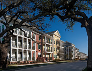 A photo of the Columbia Parc Apartment Community as seen through two massive live oak trees