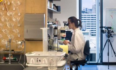 A student conducts microscopic research at the Parker H. Petit Science Center at Georgia State University