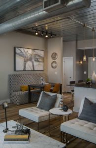 A view of the modern and interesting model unit living room at the Goodwynn at Town Brookhaven