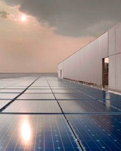 A view of the sun reflecting off the rooftop solar panels at the NASA Space Flight Center