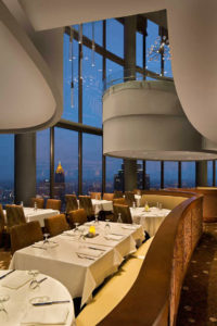 An interesting twilight view of the banquettes and interesting ceiling forms of the circular Sundial Restaurant