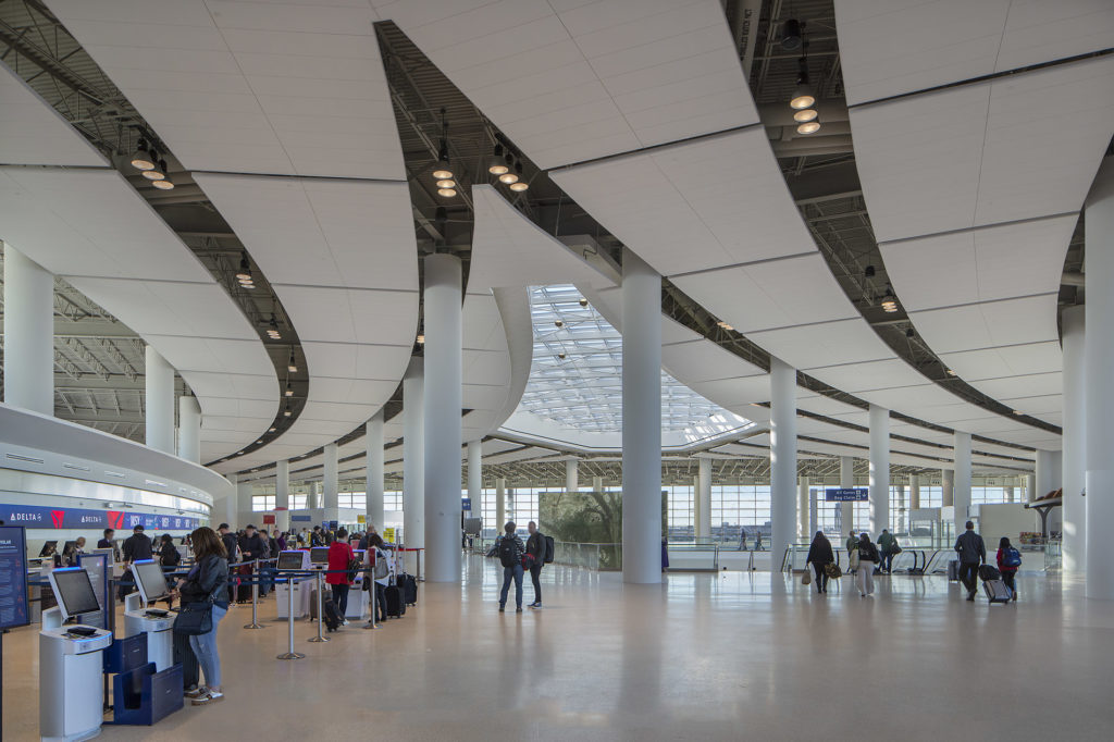 A view of the expansive and sunlit terminal ticketing area at New Orleans International Airport