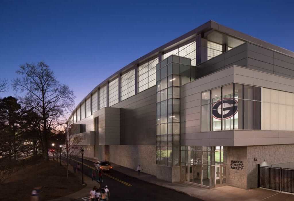 An exterior entrance at twilight view of the University of Georgia Indoor Athletic Facility.