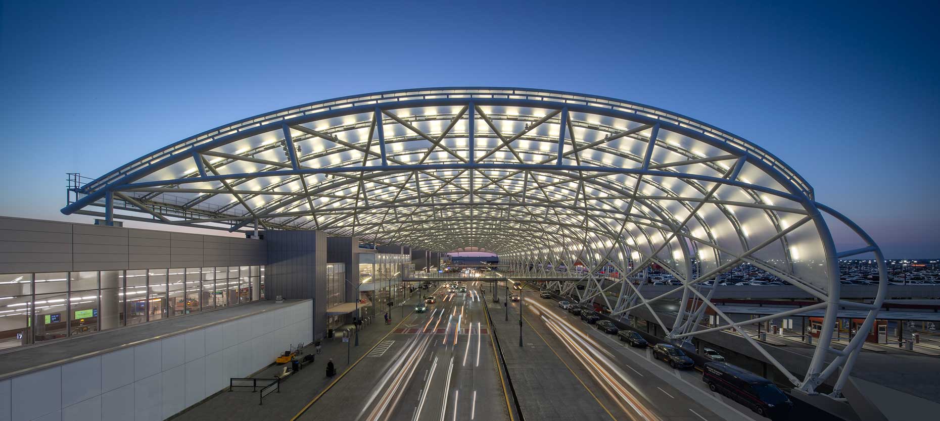 The canopy at Hartsfield Jackson Atlanta International Airport glows against a dawn sky