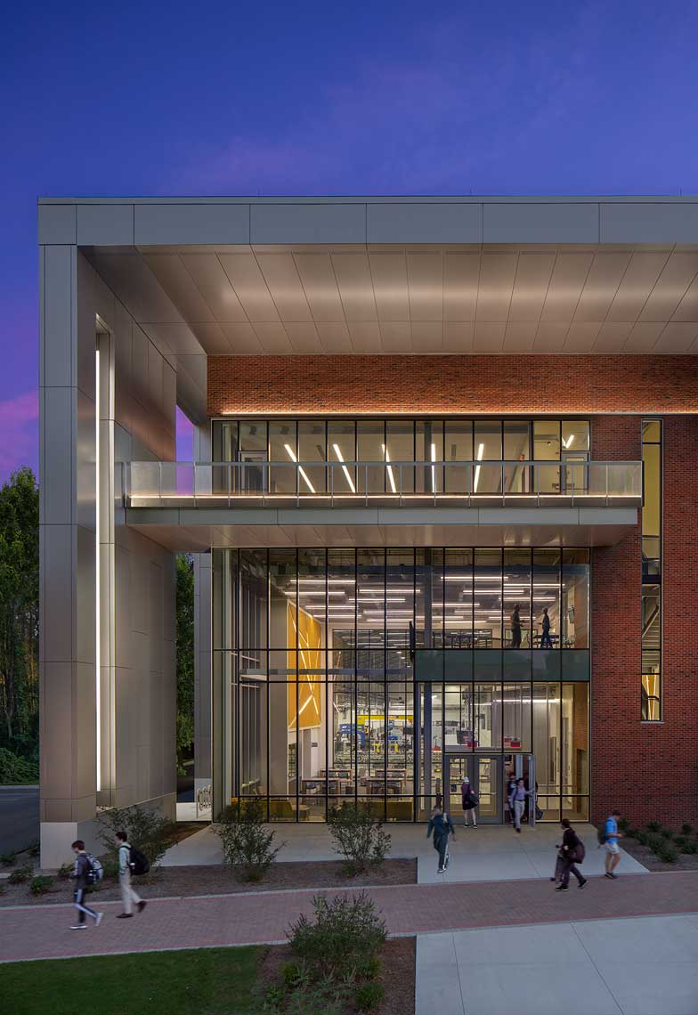 A twilight view of the illuminated entry of the GA Southern Engineering Building