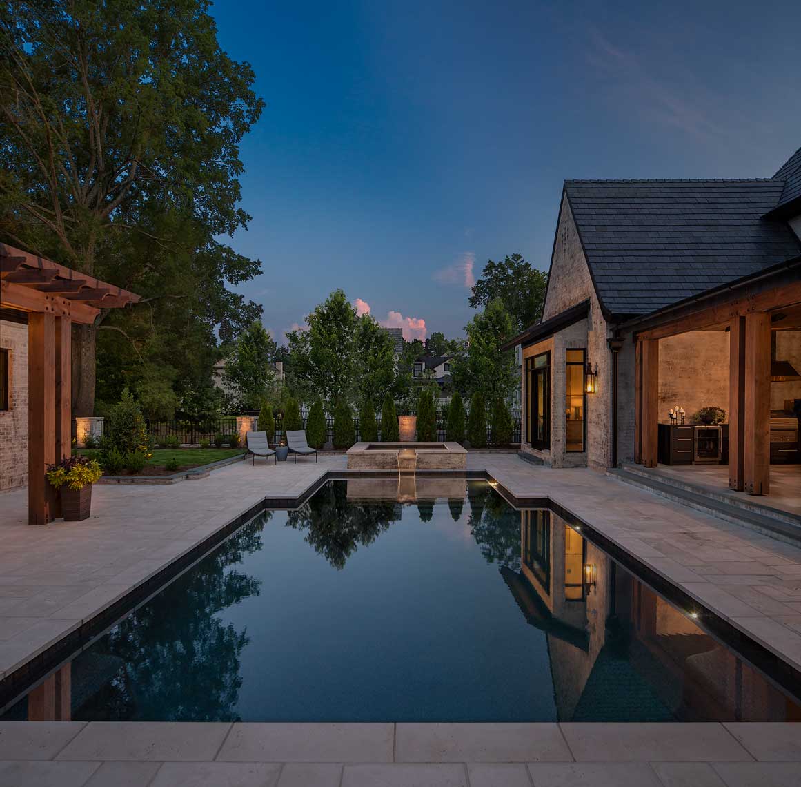 A dramatic twilight view of an Atlanta residence's pool deck
