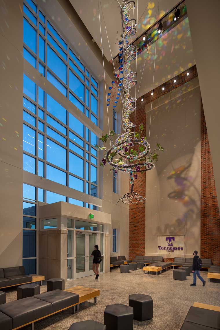 A twilight view of one of the TN Tech Lab Building lobbies, with a mutimedia sculpture