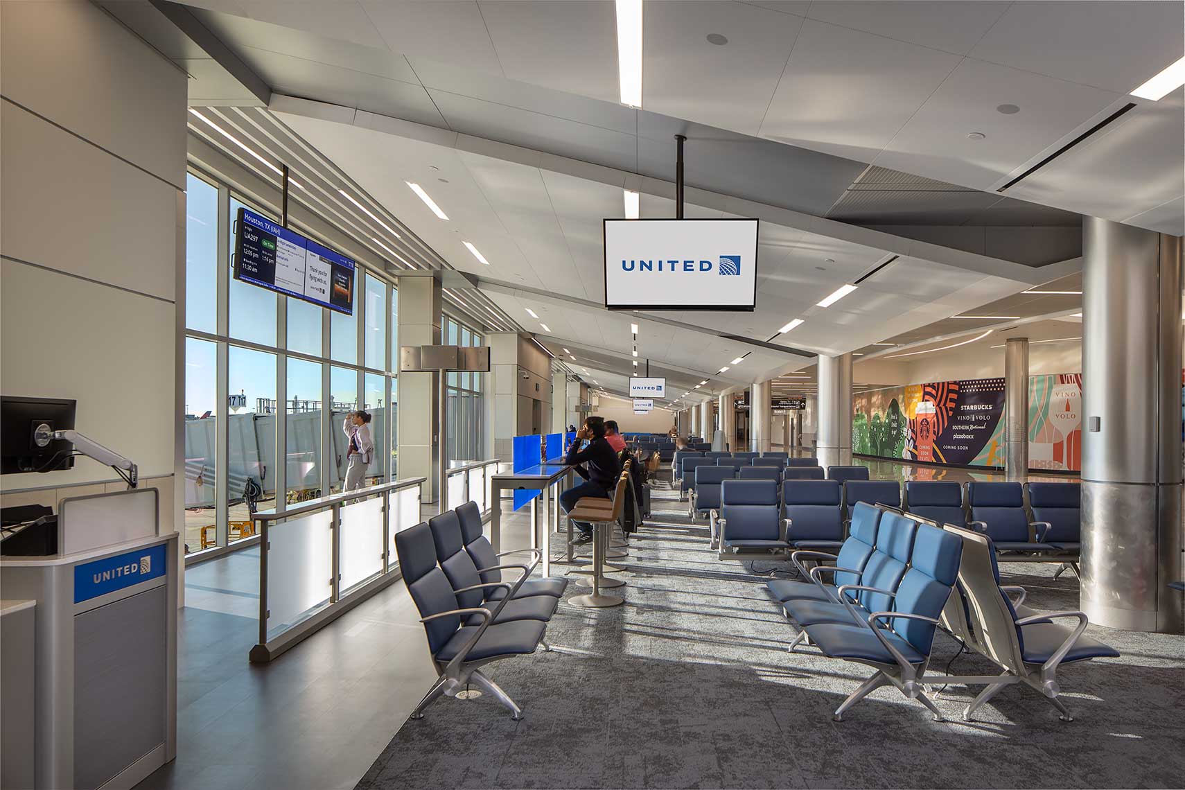 A daytime view of the gate waiting area within the Concourse T North Expansion at Hartsfield Jackson Atlanta International Airport.