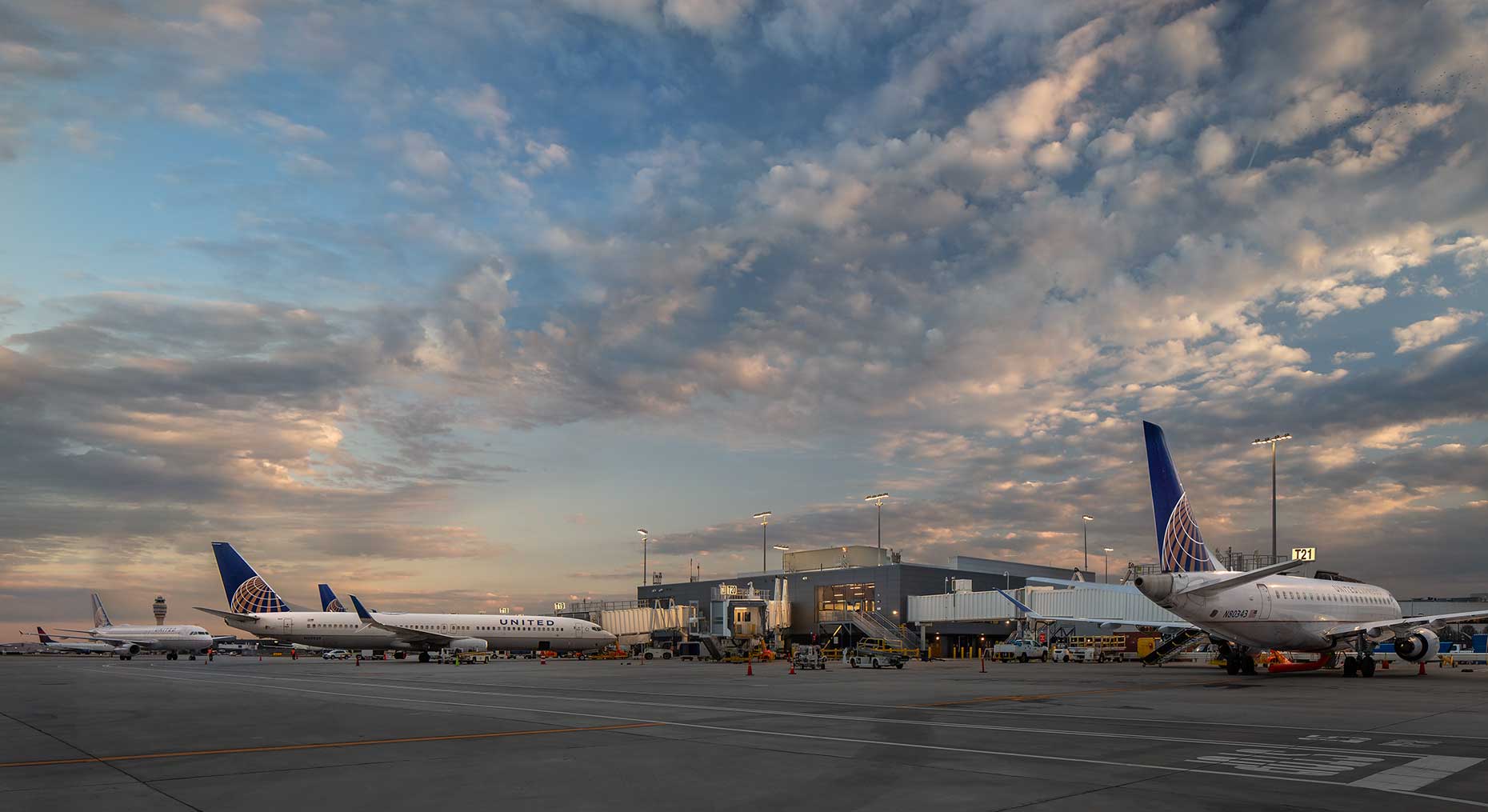 A twilight view from the tarmac of Hartsfield Concourse T North Extension with United airplanes parked at the gate