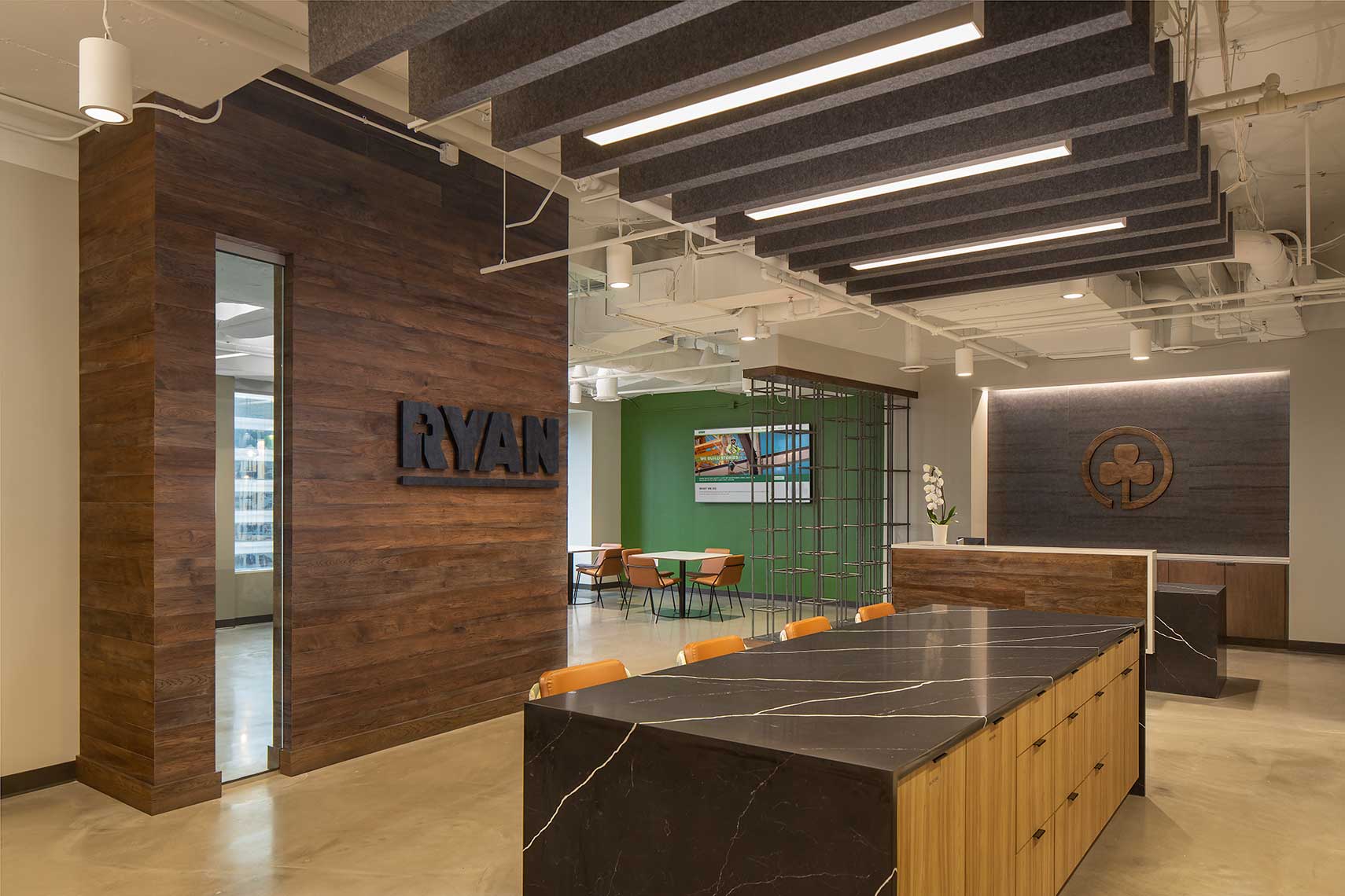 An image of the Ryan Companies' Atlanta offices reception area, with warm wood and bold graphics