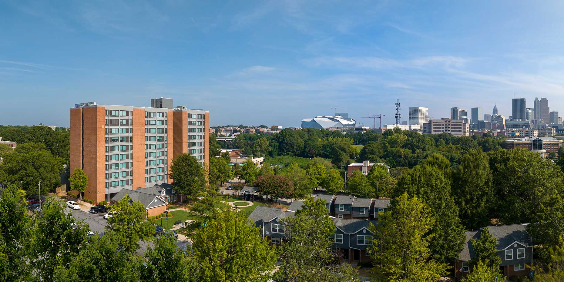 A drone view of City Views at Rosa Burney Senior Living Building with the Atlanta skyline