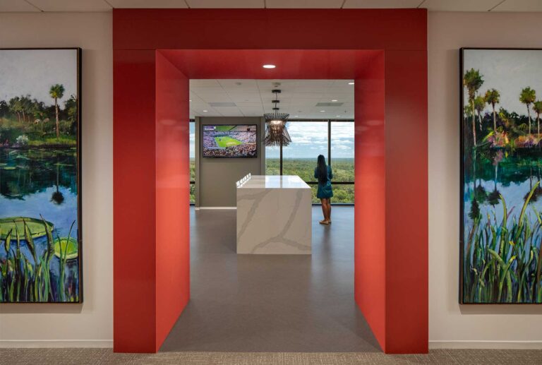 A view of an office interior showing a hallway and view into a Break Room.