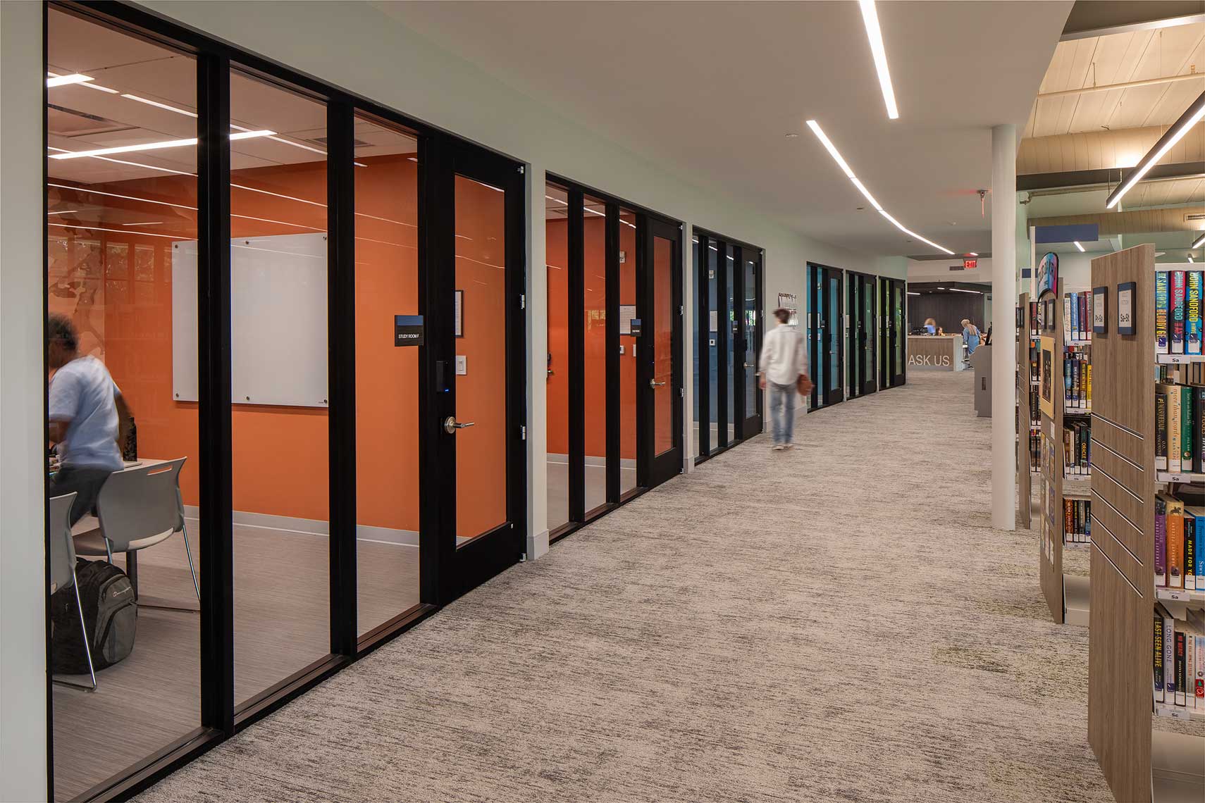 A view down the inner corridor of the Denmark Branch Library showing the private study rooms in relation to the stacks.