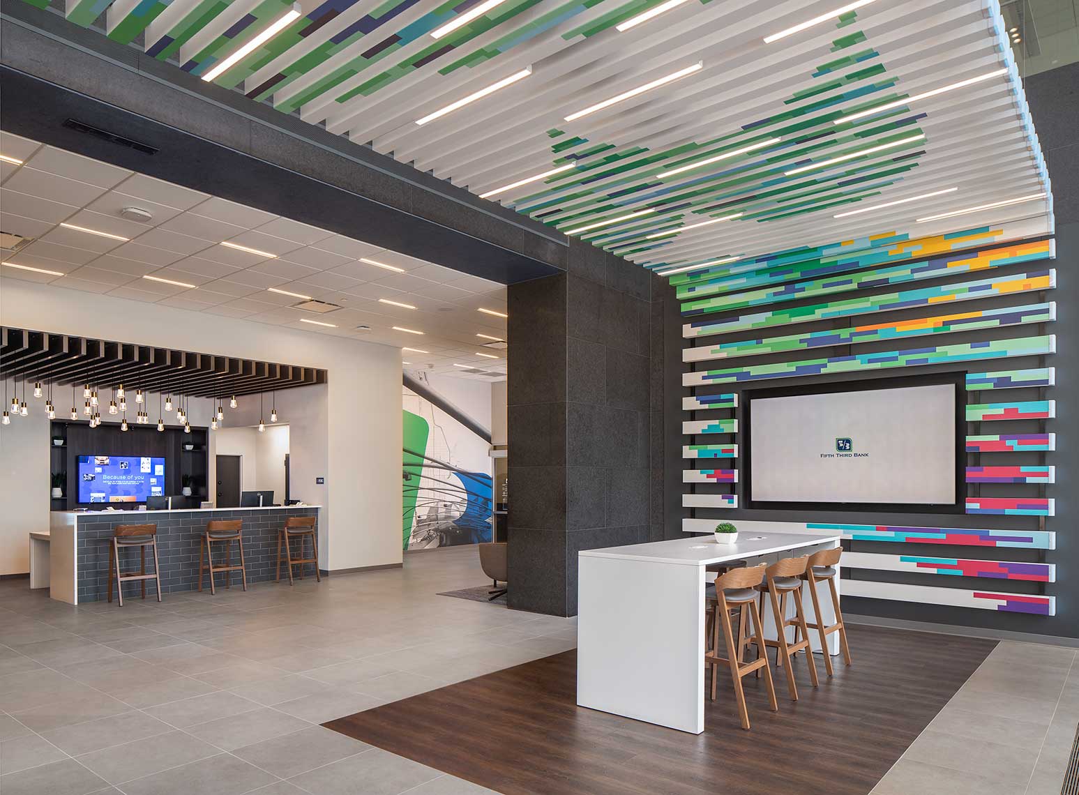 An interior view of the Fifth Third Bank branch in downtown Chicago showing colorful and whimsical graphic accents and a view to the main teller desk.