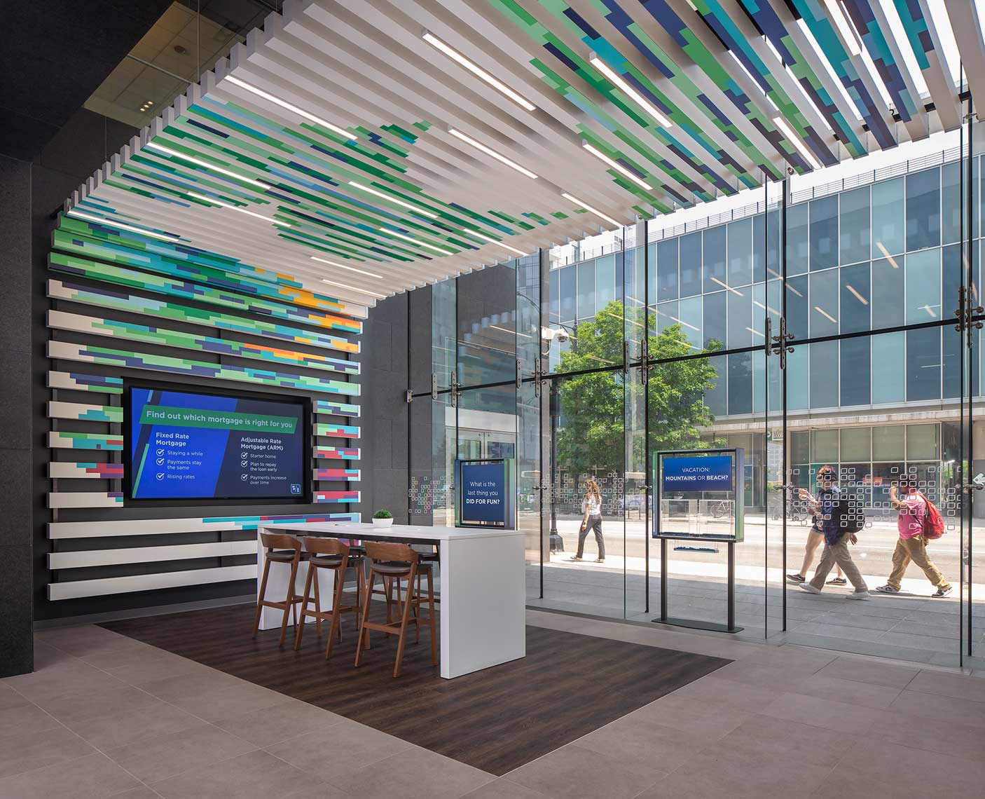 A view of the interior of the Fifth Third Bank branch in downtown Chicago and the accompanying view out of the two-story glass to the streets outside.