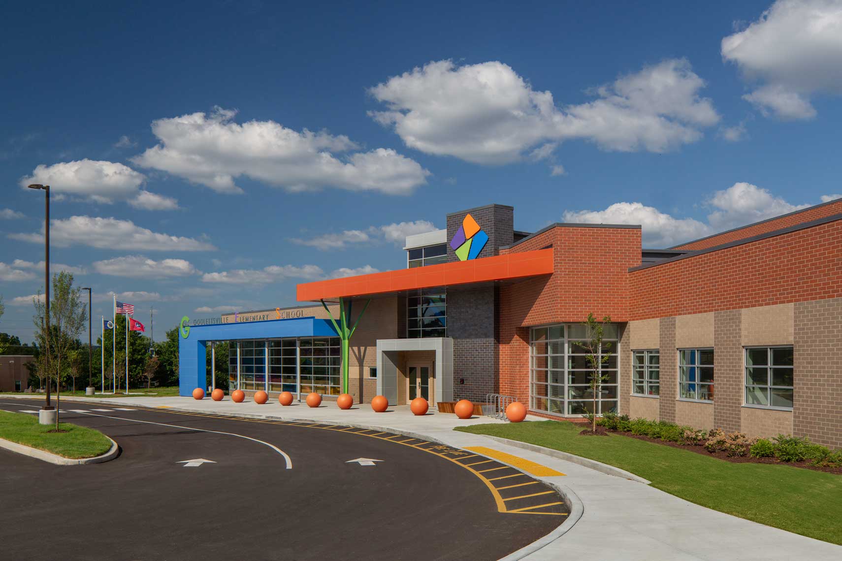 A daytime exterior view of the main drop-off and entrance to Goodlettsville Elementary School, showing bright colors on a beautiful day
