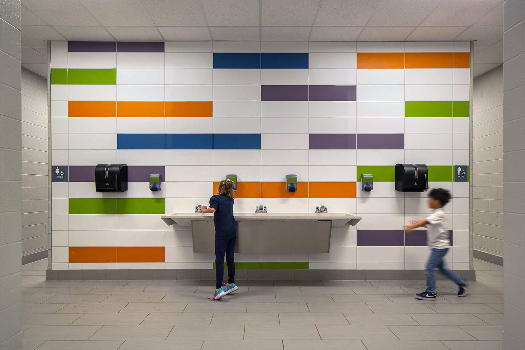 A detail view of students using the brightly colored hand-washing station at the Goodlettsville Elementary School
