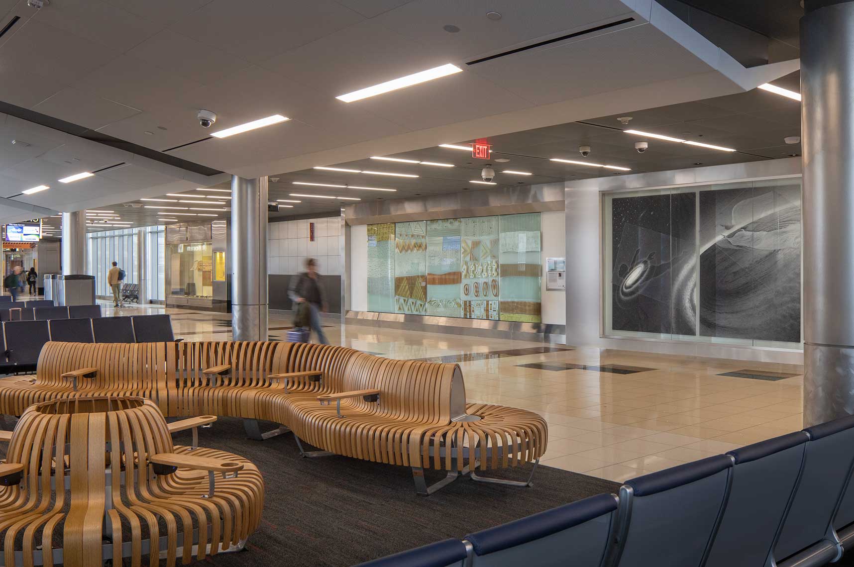 A view of the T Concourse at Hartsfield Jackson Atlanta International Airport with interesting seating and artwork displays