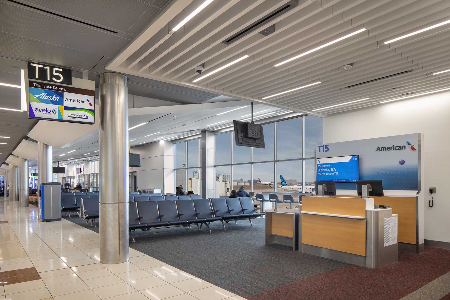 An interior view of Gate 15 on the T Concourse at Hartsfield Jackson Atlanta International Airport showing airplanes taxiing outside