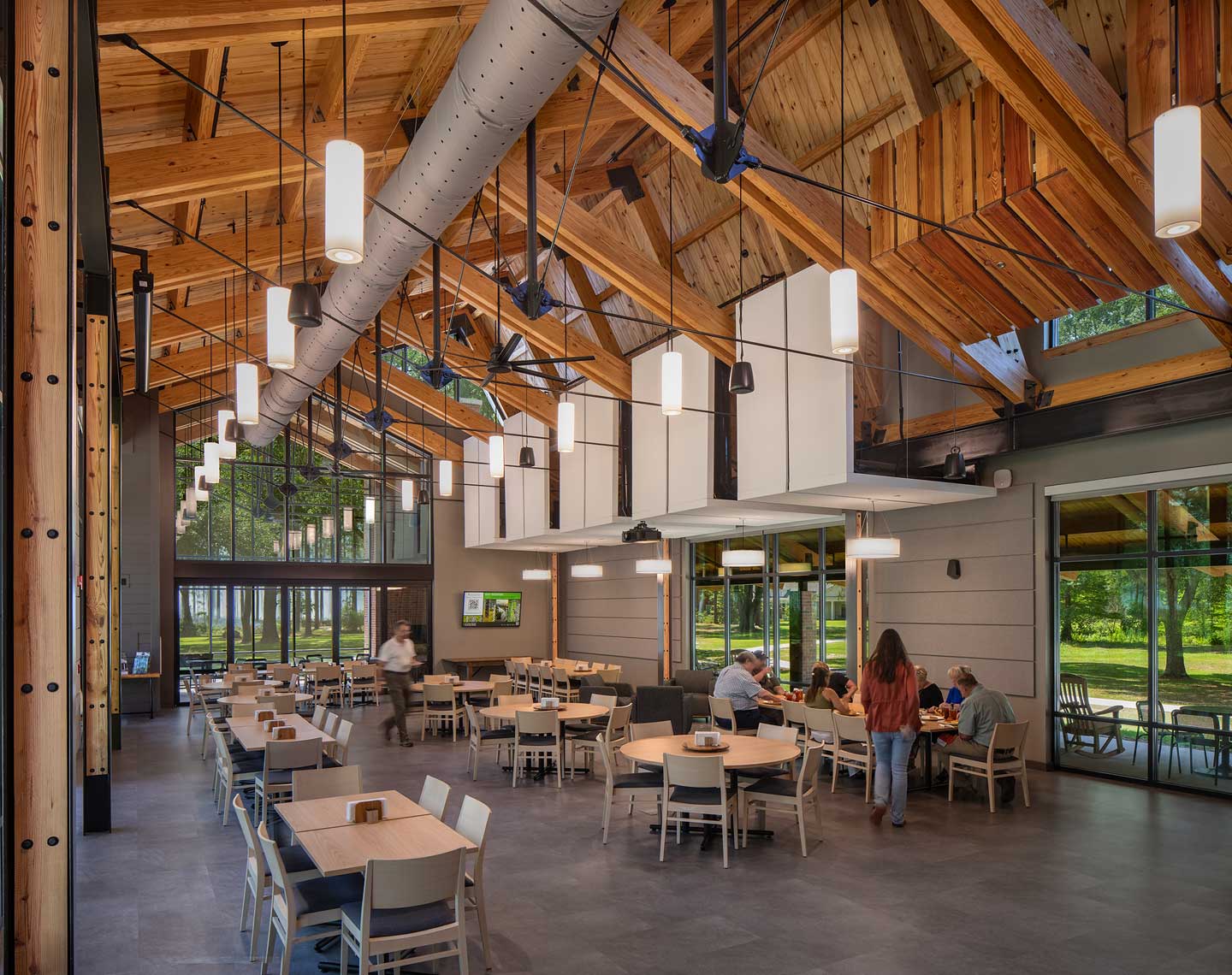 An interior view of the dining facility at The Jones Center at Ichauway in Newton, Georgia, highlighting the use of wood in the ceiling and rafters.