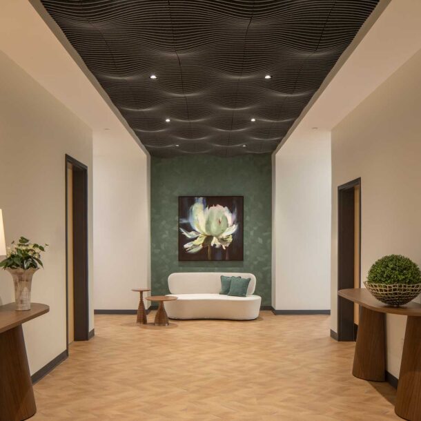 An axial view of a seating area within the administration area of the Quick Start - Hyundai Mobility Training Center of Georgia, featuring sculpted ceiling forms