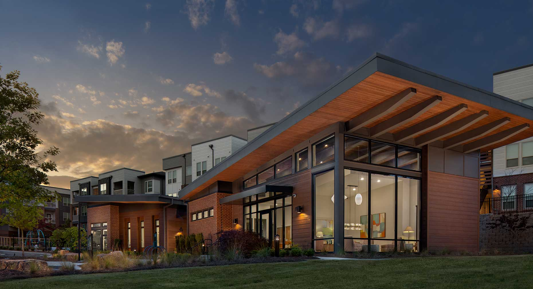 A twilight view of the striking Leasing Office at Gardenside of East Lake