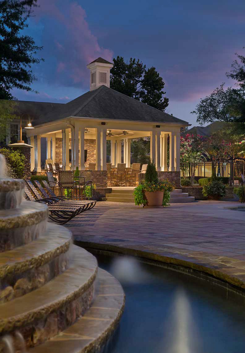 A twilight view across the fountain highlights the pool pavilion at The Reserve at Sugarloaf