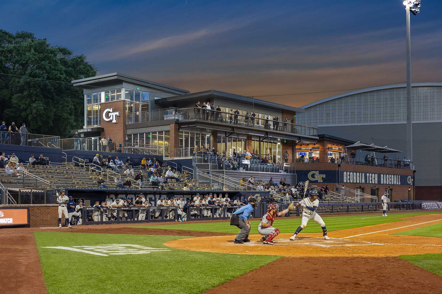 A view of a baseball game and the Field House at twilight at GA Tech Baseball
