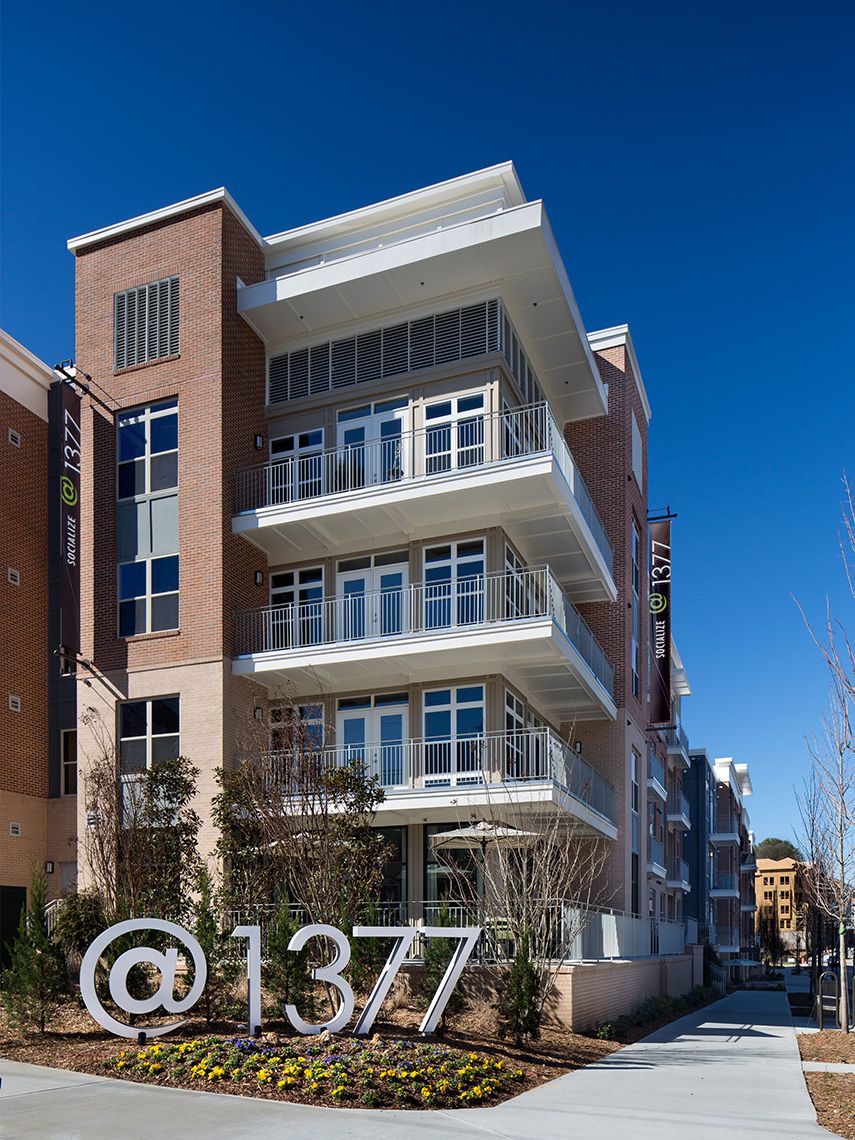 An exterior pedestrian view of the @1377 Apartments highlighting the wrap-around balconies