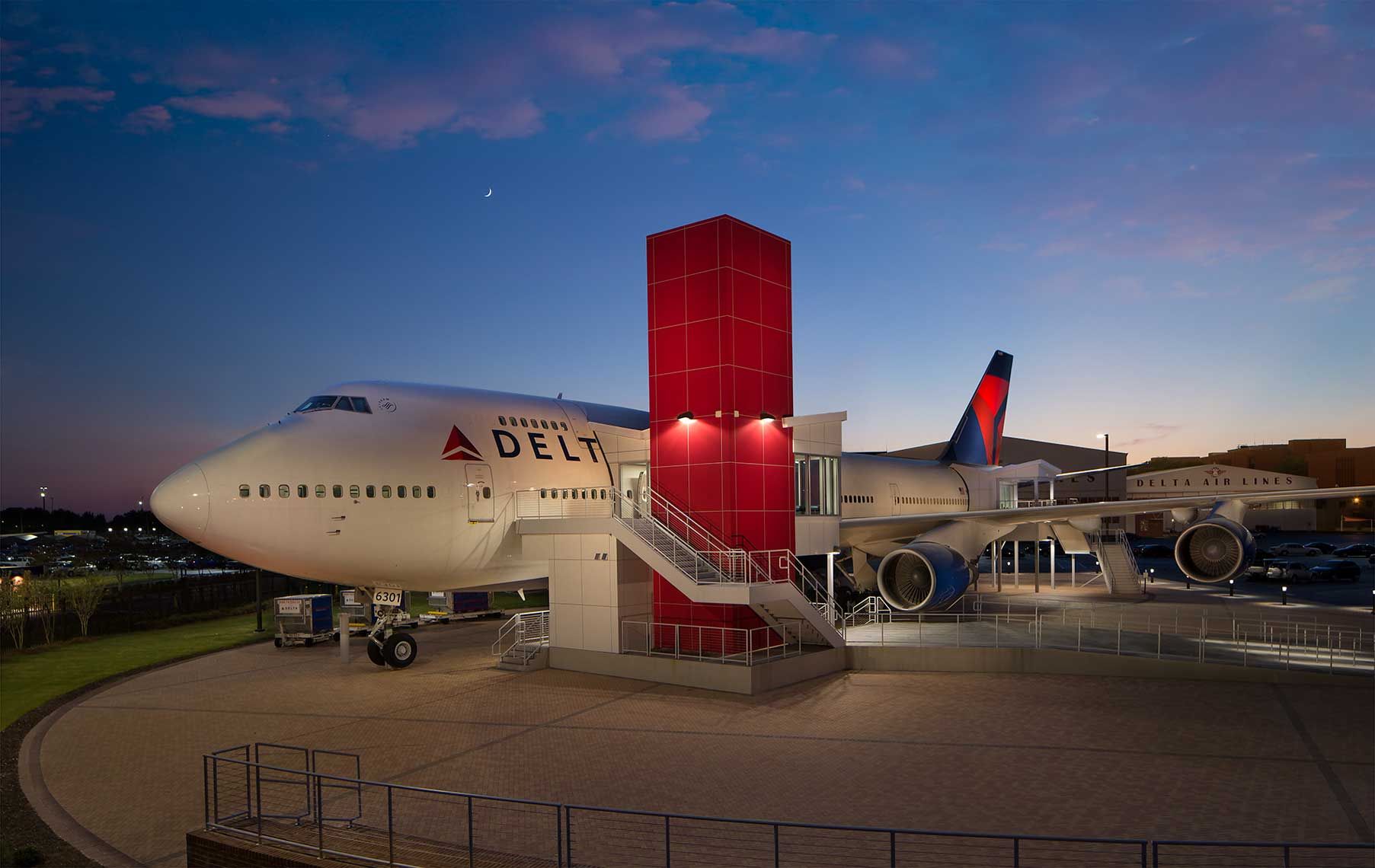 Exterior twilight view of the 747 museum exhibit on the tarmac at the Delta Flight Museum