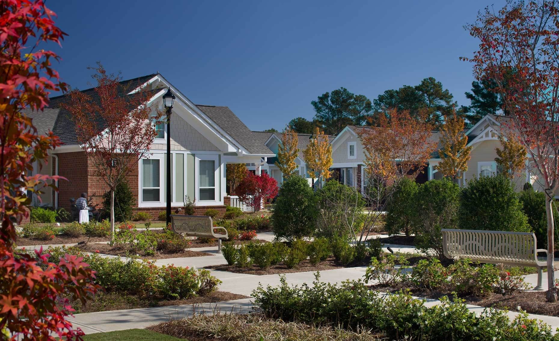 A photo of a landscaped courtyard on a colorful autumn day at The Cottages at Arbor Pointe