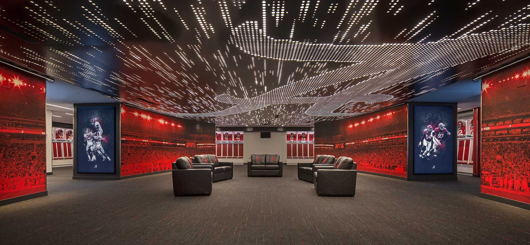 A symmetrical view of the locker room at the Univ. of Alabama, showing the custom ceiling graphics