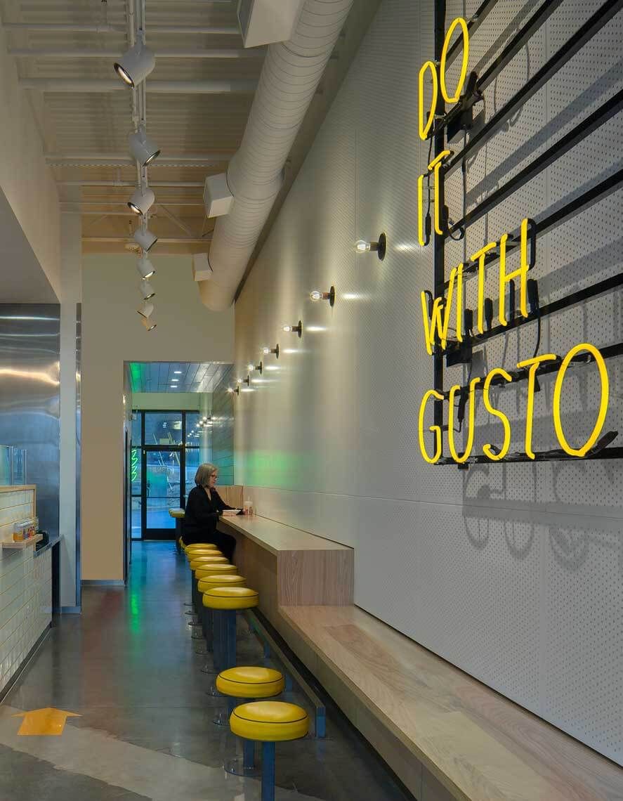 A view of the indoor seating and accent neon at the Gusto! West Midtown location